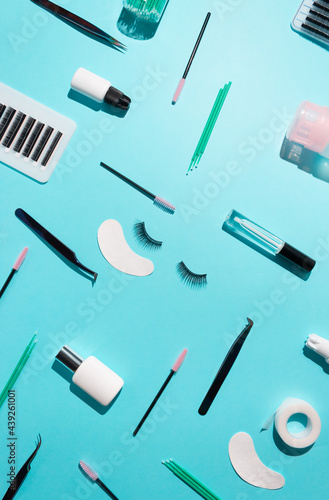 Tools for eyelash extension on a blue background. Artificial eyelashes, self-care. Top view.
