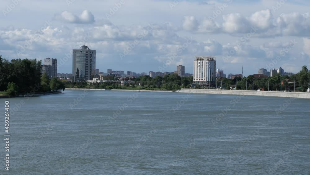Urban landscape. The river on the background of a cloudy sky and the city. The Kuban River in Krasnodar. Static frame Urban landscape. The river on the background of a cloudy sky and the city. The Kuban River in Krasnodar. Static frame
