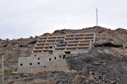 Rugged Stone Hillside with Unfinished Abandoned Building  photo