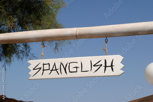 Sign 'Spanglish' above Entrance to Public Park photo