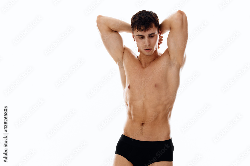 sporty man holding hands behind head workout macho light background sporty man holding hands behind head workout macho light background