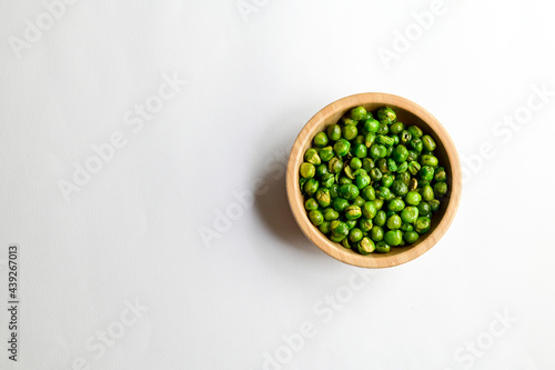 Top Views of Green Peas in a wooden bowl isolated on white background, Healthy Food Concept.