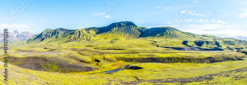 Green hills and black rocky ground of Icelandic Highlands along Laugavegur hiking trail, Iceland. Sunny summer day shot. photo