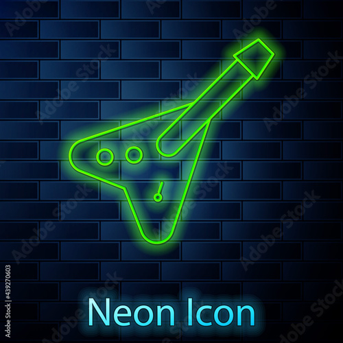 Glowing neon line Electric bass guitar icon isolated on brick wall background. Vector