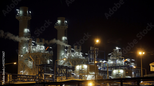 Gas turbine electrical power plant at night time for factory energy concept.
