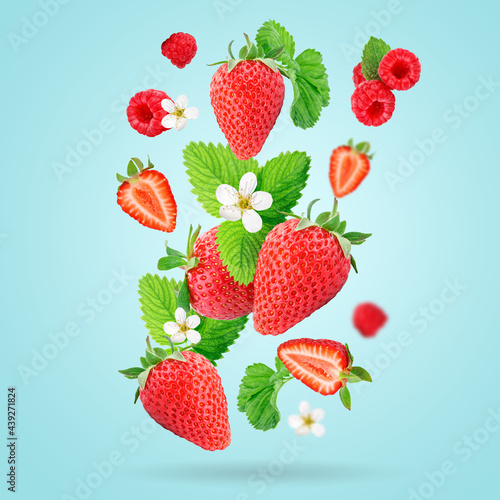 Strawberry berries levitating on a blue background. Strawberry background.