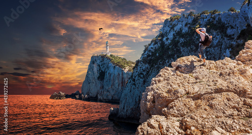 Fantastic Colorful sunset over the Lighthouse on the cliff Stunning picturesque vivid landscape over the Ionian Sea. Lefkada island. Greece. Popular travel and hiking destination and photography place
