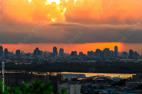 The blurred abstract background of the morning sun exposure to the tiny dust particles that surround the tall buildings in the capital, the long-term health issue of pollution