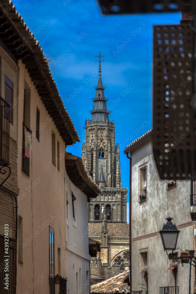 View of a buildings in Toledo city downtown and Primate Cathedral of Saint Mary of Toledo tower as background