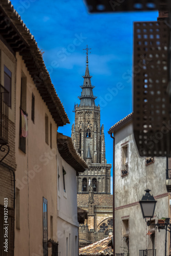 View of a buildings in Toledo city downtown and Primate Cathedral of Saint Mary of Toledo tower as background