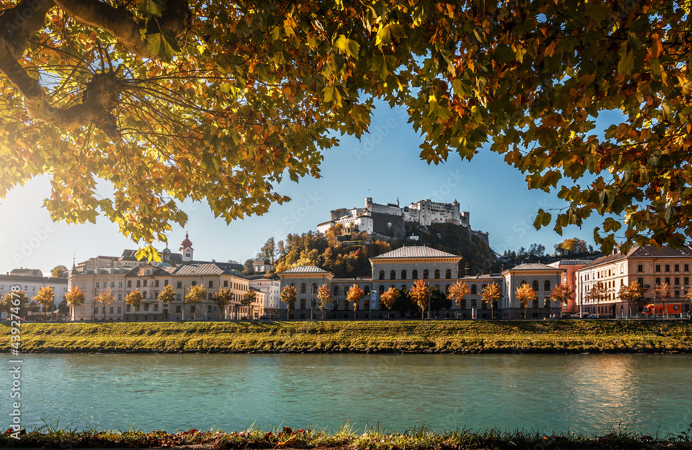 Stunning autumn view of Salzburg with famous Hohensalzburg Fortress at sunny day. Salzburg is a popular travel and hiking destination in Austria. Central Europe. Concept of an ideal resting place
