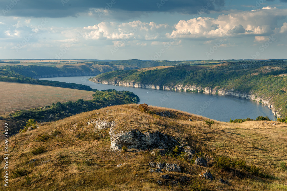 Sunny view on panorama of the Dniester River. landscape with canyon, forest and a river in front. beautiful nature scenery wth perfect blue sky and calm majestic river. Dniester River. Ukraine