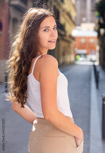 Portrait of cheerful woman standing on a city street