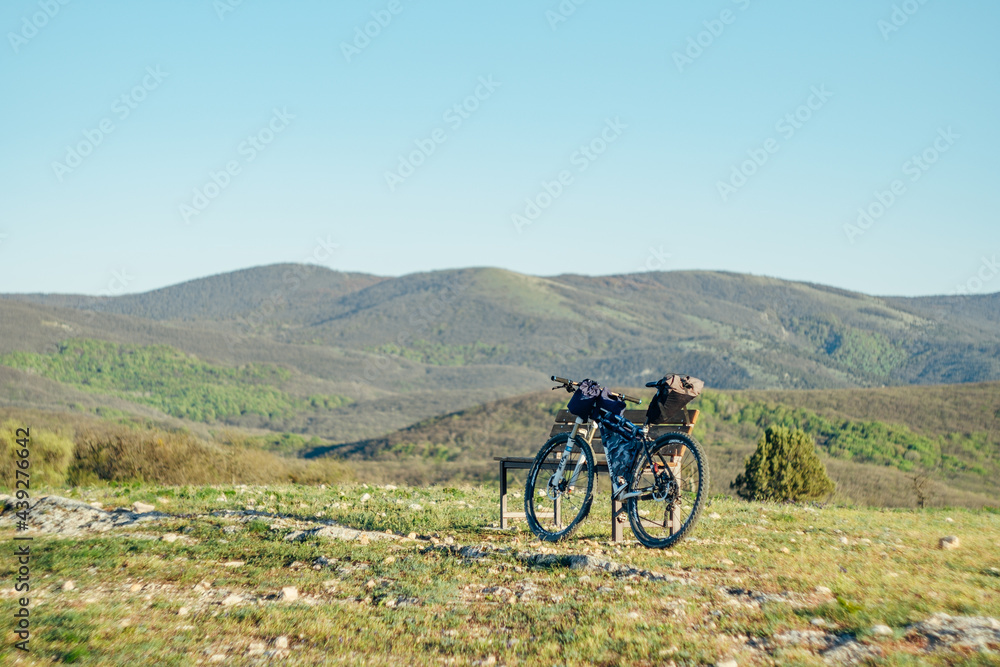 Bicycle equipped with bikepacking stuff in the mountains Bicycle equipped with bikepacking stuff in the mountains
