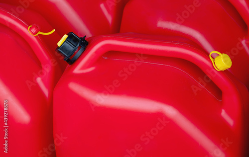 red plastic tanks gasoline tank petrol engine power fuel photo