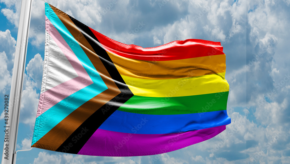 Pride rainbow lgbt gay flag being waved in the breeze against a sunset ...