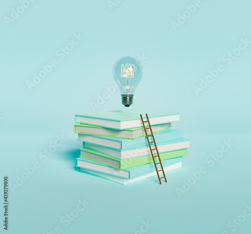 Stack of books with light bulb and ladder