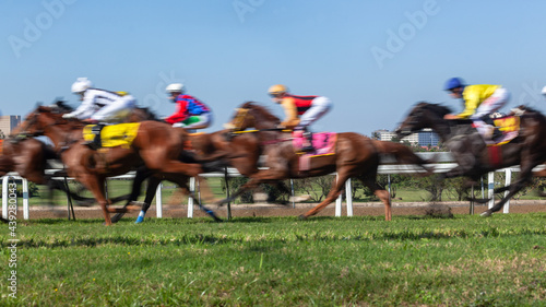 Horses Racing  Jockeys Riding  Panoramic Motion Speed Blur Closeup Photo Action Image. photo