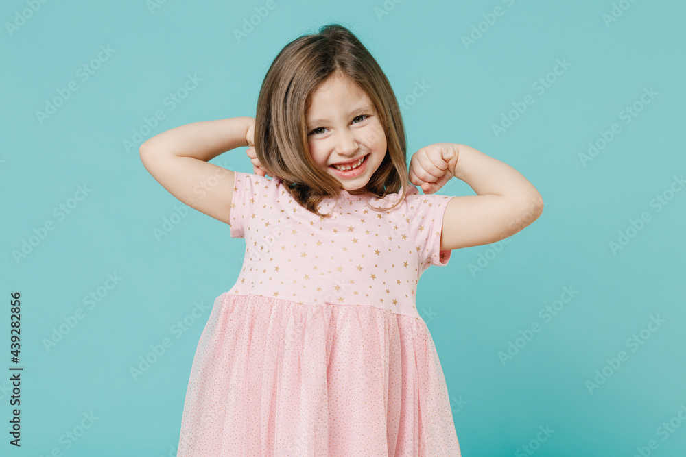 Little toothy smiling cheery cute kid girl 5-6 years old wears pink dress have fun isolated on blue color background child studio portrait. Mother's Day love family people childhood lifestyle concept. Little toothy smiling cheery cute kid girl 5-6 years old wears pink dress have fun isolated on blue color background child studio portrait. Mother's Day love family people childhood lifestyle concept.
