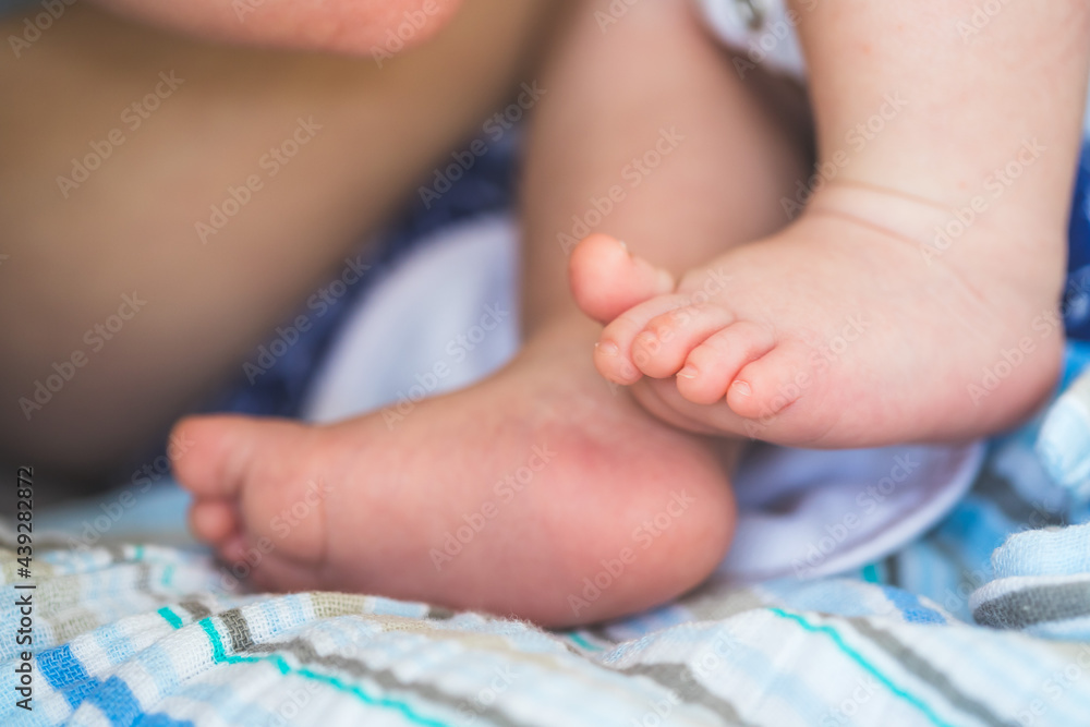 Baby and newborn concept: Close up of newborn baby feet on baby blanket Baby and newborn concept: Close up of newborn baby feet on baby blanket