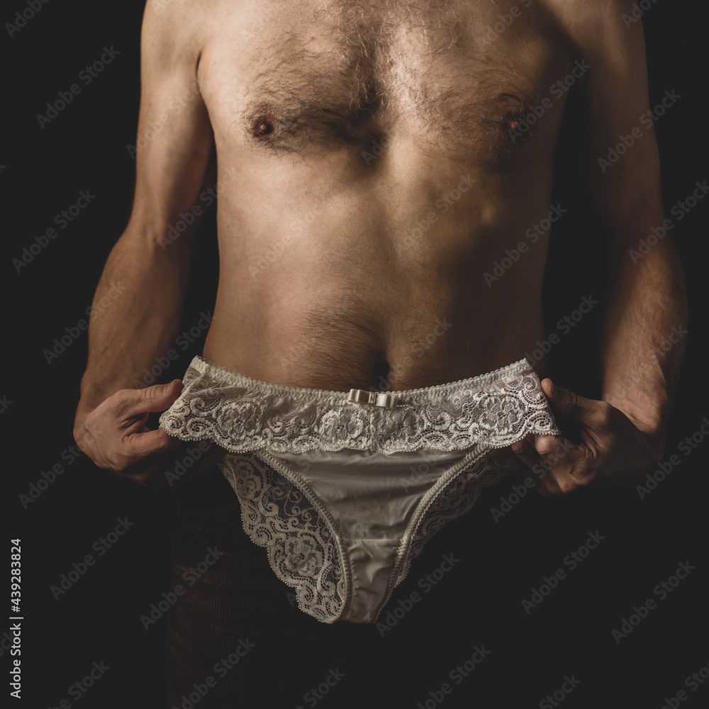 Unrecognizable young man trying on female lace panties Stock Photo