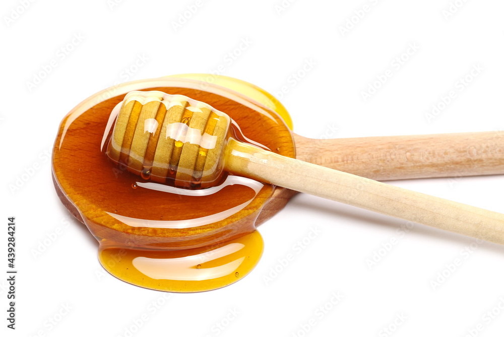 Honey puddle in wooden spoon with dipper isolated on white background Honey puddle in wooden spoon with dipper isolated on white background