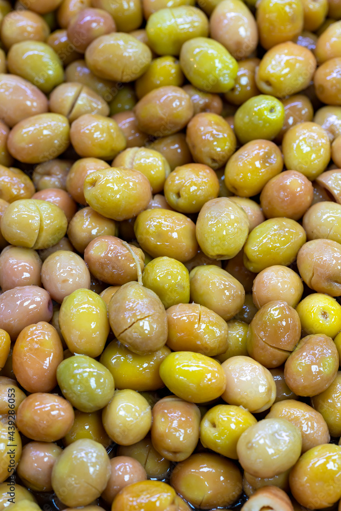 Scratched green olives. Close up. Green olives as background texture Scratched green olives. Close up. Green olives as background texture