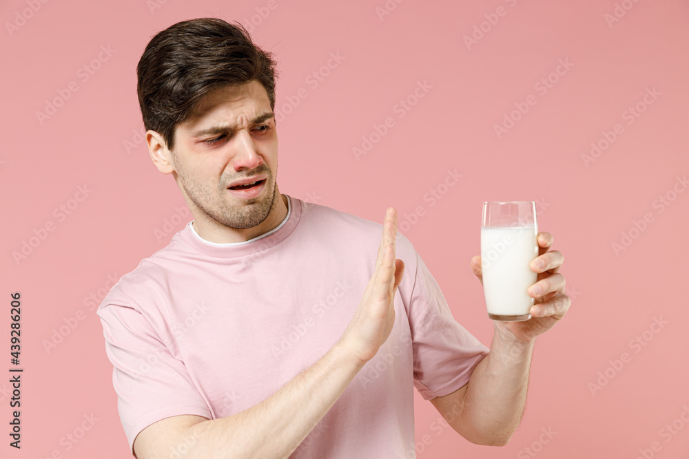 Sick sad unhealthy ill allergic man has red watery eyes, runny stuffy