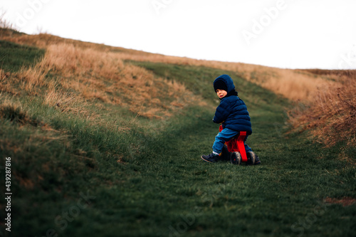 Wallpaper Mural the child is traveling. Boy on a tricycle in the mountain. family travel Torontodigital.ca