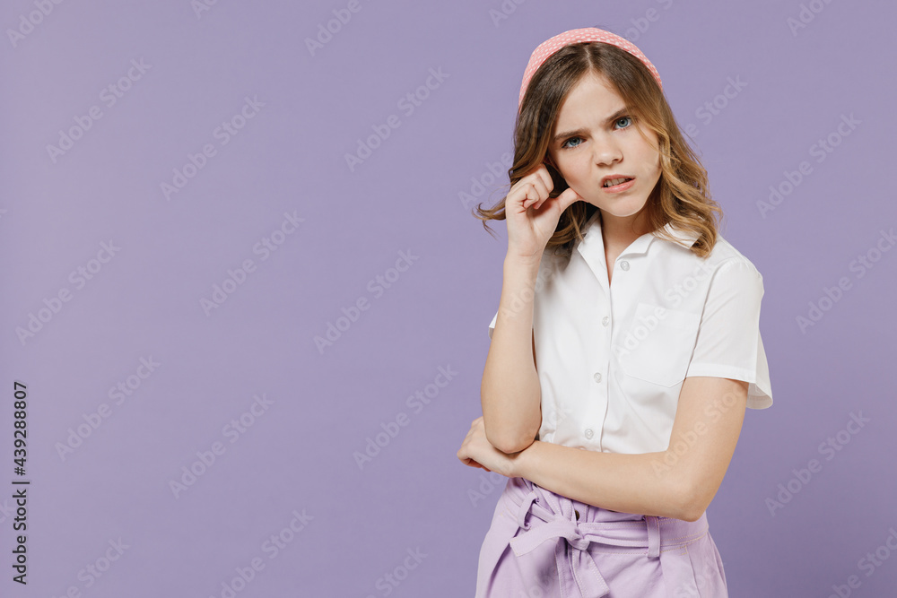 Little sad confused shocked puzzled blonde kid girl 12-13 years old in white shirt looking camera prop up forehead isolated on purple background children studio portrait. Childhood lifestyle concept. Little sad confused shocked puzzled blonde kid girl 12-13 years old in white shirt looking camera prop up forehead isolated on purple background children studio portrait. Childhood lifestyle concept.