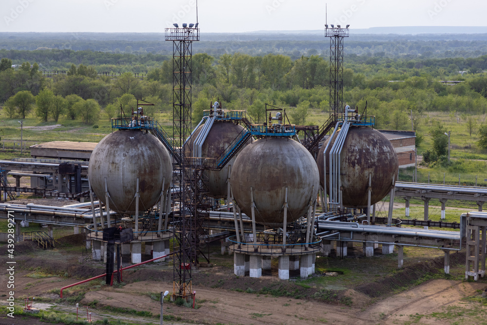 Oil refinery in the summer against the backdrop of nature. Oil refinery in the summer against the backdrop of nature.