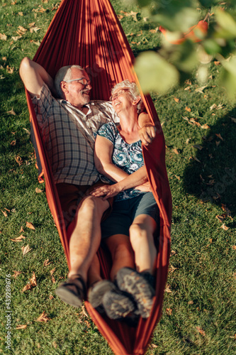 senior couple bonding on the hammock - free time together - positive retired people #439289676