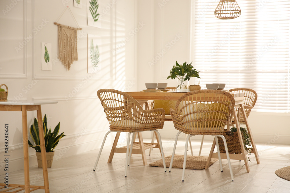 Stylish wooden dining table and chairs in room. Interior design