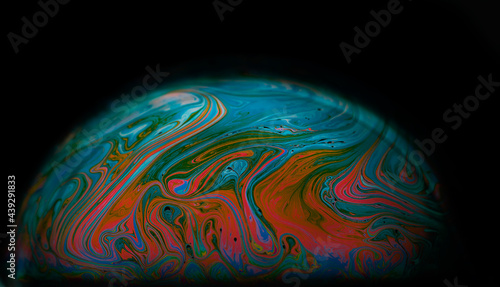 Colourful of art wave and patterns with light effects in soap bubbles isolated on black background.