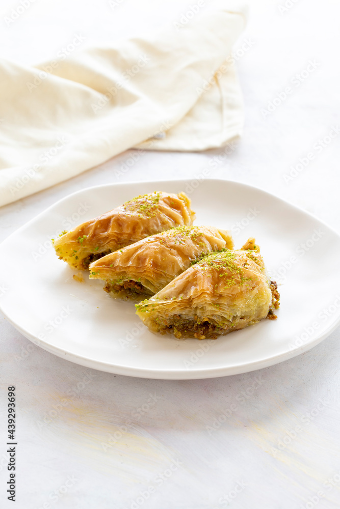 Turkish Dessert Sobiyet Baklava. Turkish pistachio baklava on a white background. Local name şöbiyet baklava Turkish Dessert Sobiyet Baklava. Turkish pistachio baklava on a white background. Local name şöbiyet baklava