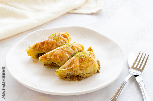 Turkish Dessert Sobiyet Baklava. Turkish pistachio baklava on a white background. Local name şöbiyet baklava