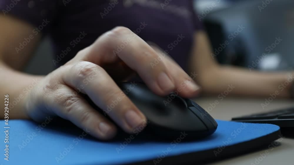 Woman works on the computer using the mouse. Close up hand. Woman works on the computer using the mouse. Close up hand.