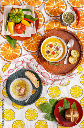 Wallpaper Mural Flat lay photography of a vegan pumpkin cream soup and bread. Vegetables recipe.  Top view of an puree of seasonal products with spices and retro pattern fabric tablecloth. Torontodigital.ca