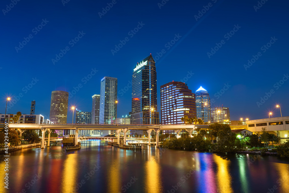 Tampa skyline at night with Hillsborough river in the foreground