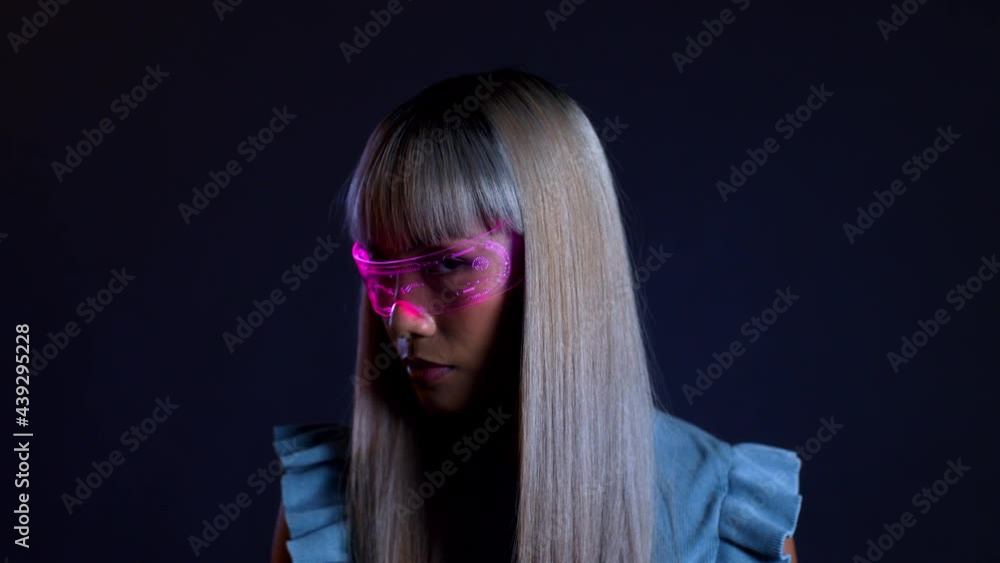 Young woman looking through futuristic light therapy glasses Young woman looking through futuristic light therapy glasses