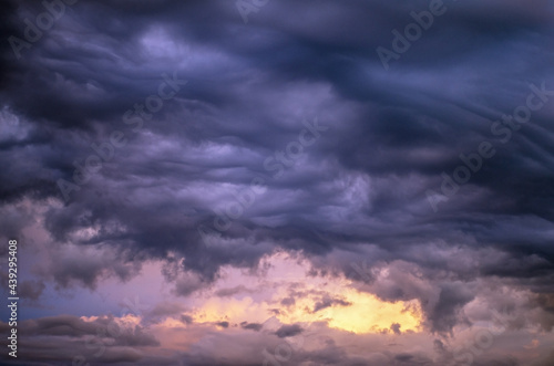 Sunset sky with heavy clouds-altocumulus undulatus asperitas.