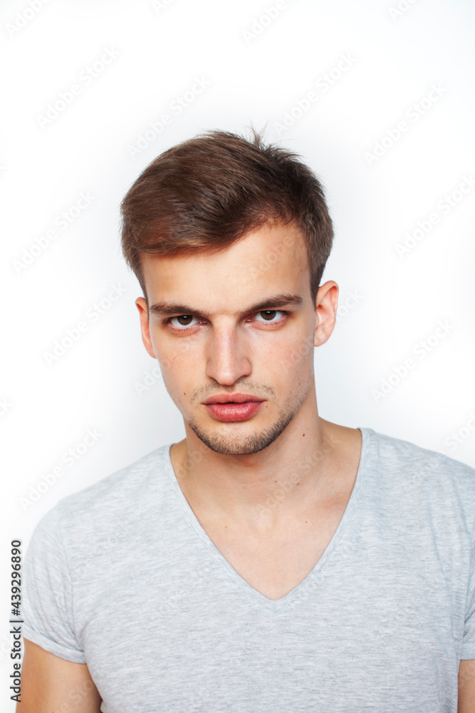Obraz premium young handsome teenage hipster guy posing emotional, happy smiling against white background isolated, lifestyle people concept