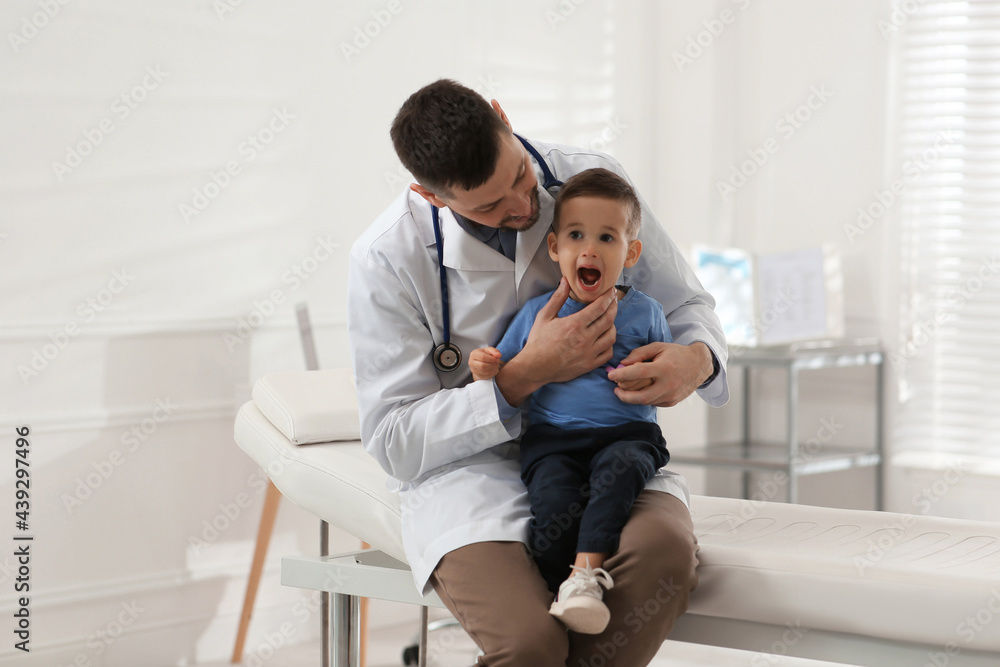 Pediatrician examining cute little boy at hospital Pediatrician examining cute little boy at hospital