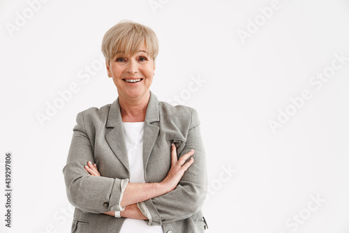 European mature woman laughing while posing with arms crossed