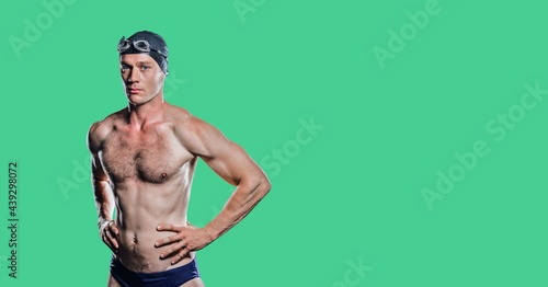 Composition of male swimmer with copy space isolated on green background
