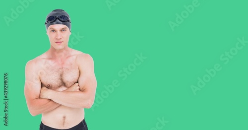 Composition of male swimmer with copy space isolated on green background