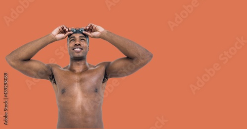 Composition of male swimmer with copy space isolated on orange background