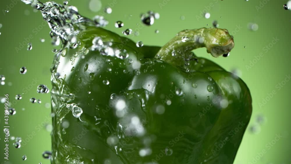 Super slow motion of rotating green pepper with splashing water. Filmed on high speed cinema camera, 1000 fps. Super slow motion of rotating green pepper with splashing water. Filmed on high speed cinema camera, 1000 fps.
