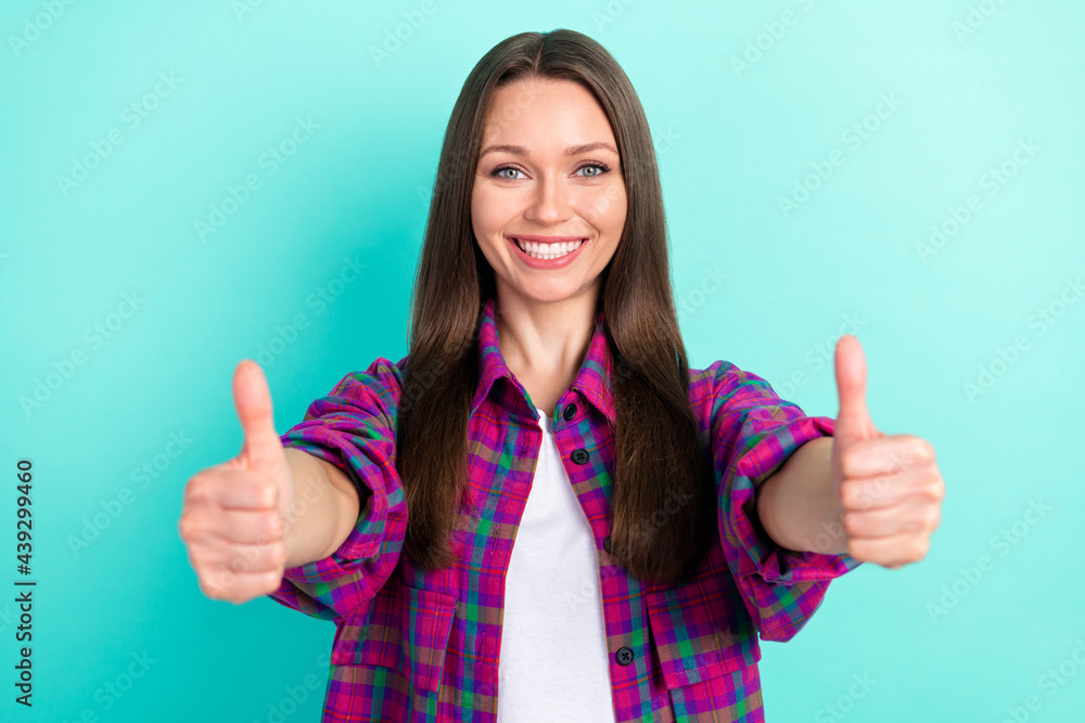 Portrait of attractive cheerful content girl giving thumbup solution ad isolated over bright teal green color background Portrait of attractive cheerful content girl giving thumbup solution ad isolated over bright teal green color background