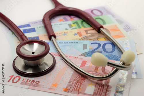 Kosten und Einnahmen im Gesundheitswesen mit Euro Banknote und Stethoskop